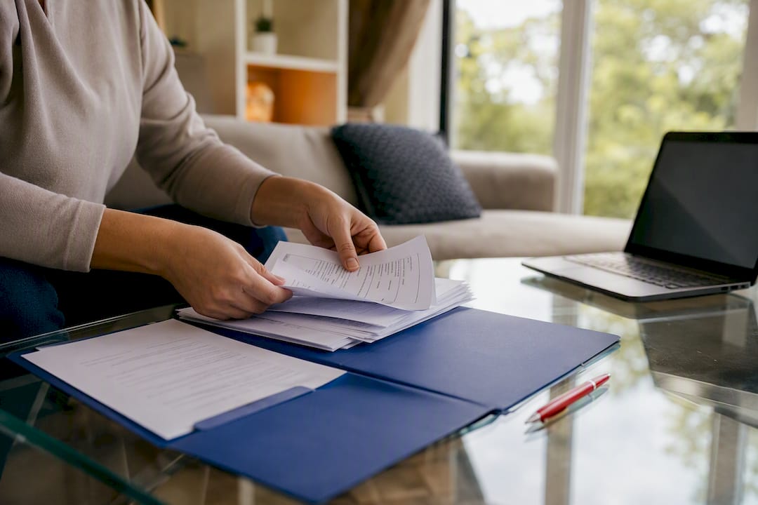 Hands arranging official bank statements