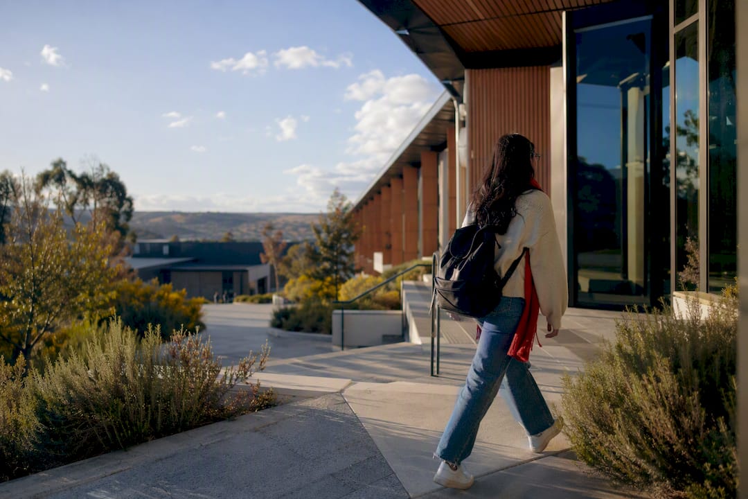 Student entering regional university campus
